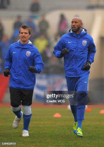 Joel Griffiths and Nicolas Anelka of Shanghai Shenhua warms up prior to a warm-up match between Shanghai Shenhua and Hunan Xiangtao at Shenhua...