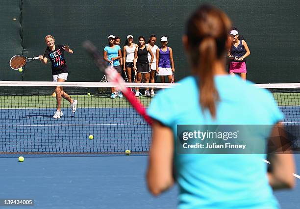 Flavia Pennetta of Italy plays tennis with the children in a kids clinic during day two of the WTA Dubai Duty Free Tennis Championship on February...