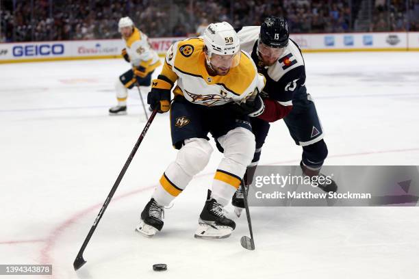 Roman Josi of the Nashville Predators fights for control of the puck against Valeri Nichushkin of the Colorado Avalanche in the first period at Ball...