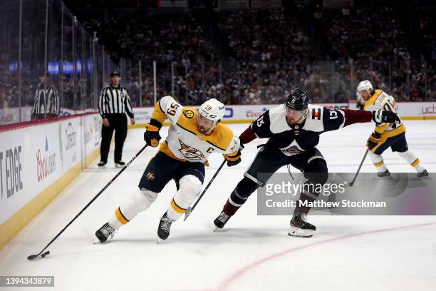 Roman Josi of the Nashville Predators fights for control of the puck against Valeri Nichushkin of the Colorado Avalanche in the first period at Ball...
