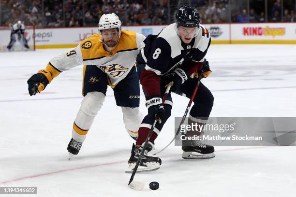 Filip Forsberg of the Nashville Predators fights for control of the puck against Cale Makar of the Colorado Avalanche in the second period at Ball...