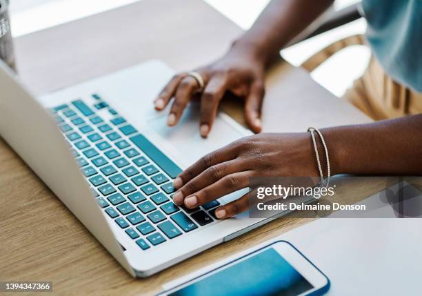 afrikanische geschäftsfrau, die allein in einem büro auf einem laptop recherchiert und plant - raised finger stock-fotos und bilder