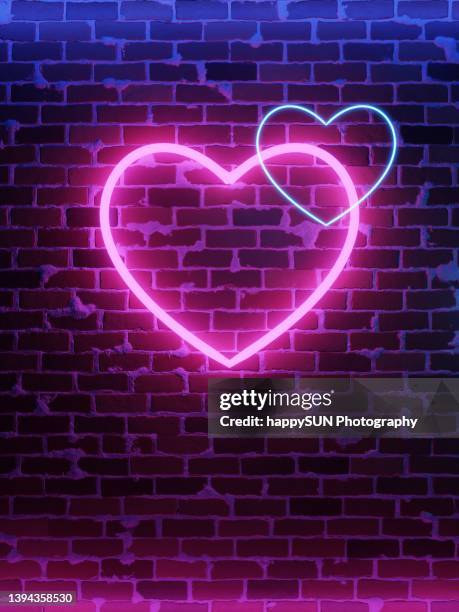 neon heart. bright night neon on brick wall - glowing heart stock pictures, royalty-free photos & images