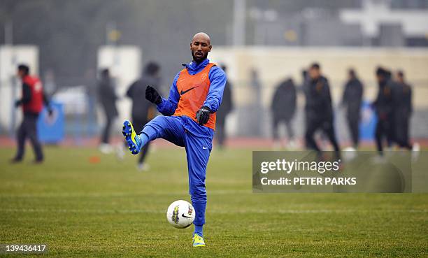 French striker Nicolas Anelka warms up before his team Shanghai Shenhua plays in a friendly match against Hunan Xiangtao at their training ground in...