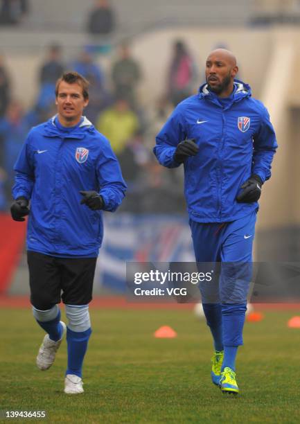 Joel Griffiths and Nicolas Anelka of Shanghai Shenhua warms up prior to a warm-up match between Shanghai Shenhua and Hunan Xiangtao at Shenhua...