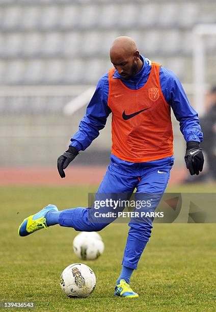 French striker Nicolas Anelka warms up before his team Shanghai Shenhua plays in a friendly match against Hunan Xiangtao at their training ground in...