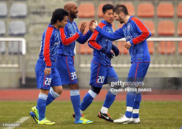 French striker Nicolas Anelka celebrates scoring a goal as he plays with his team Shanghai Shenhua in a friendly match against Hunan Xiangtao at...