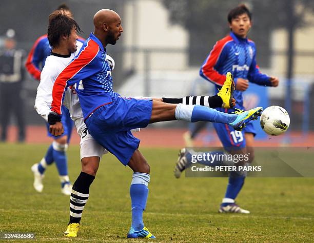 French striker Nicolas Anelka plays with his team Shanghai Shenhua in a friendly match against Hunan Xiangtao at their training ground in Shanghai on...