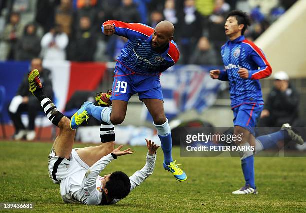 French striker Nicolas Anelka plays with his team Shanghai Shenhua in a friendly match against Hunan Xiangtao at their training ground in Shanghai on...