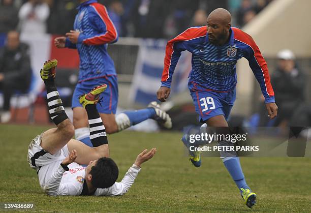 French striker Nicolas Anelka plays with his team Shanghai Shenhua in a friendly match against Hunan Xiangtao at their training ground in Shanghai on...