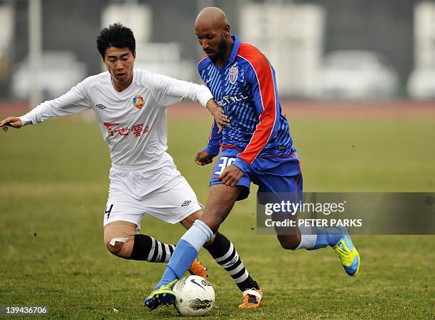 French striker Nicolas Anelka plays with his team Shanghai Shenhua in a friendly match against Hunan Xiangtao at their training ground in Shanghai on...