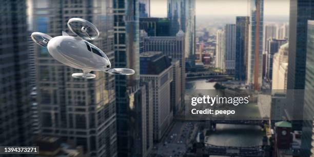 evtol electric vertical take off and landing aircraft flying through skyscrapers - aircraft skyscrapers stockfoto's en -beelden