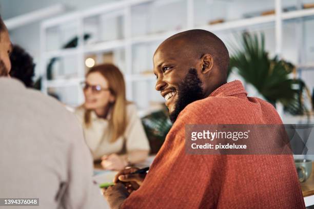 man smiling in a meeting at work. man happy at work. - multiracial group stock pictures, royalty-free photos & images