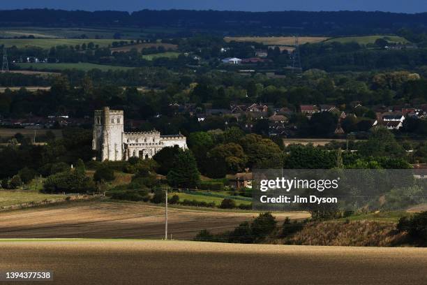 Edlesborough's 'Church on the Hill', the Church of St Mary the Virgin is bathed in a patch of sunlight surrounded by farm land, seen from Ivinghoe...