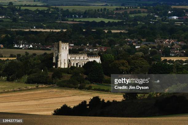 Edlesborough's 'Church on the Hill', the Church of St Mary the Virgin is bathed in a patch of sunlight surrounded by farm land, seen from Ivinghoe...