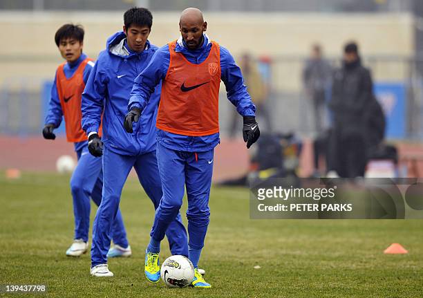 French striker Nicolas Anelka warms up with his team Shanghai Shenhua before a friendly match against Hunan Xiangtao at their training ground in...