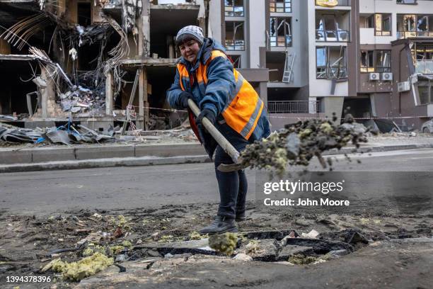 City worker cleans up the site of a missile strike in the Shevchenkivskyi district on April 29, 2022 in Kyiv, Ukraine. Kyiv Mayor Vitali Klitschko...