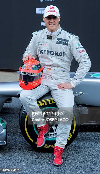 Mercedes Petronas F1 team driver German Michael Schumacher poses after unveiling the W03 2012 car during day one of Formula One winter testing on...