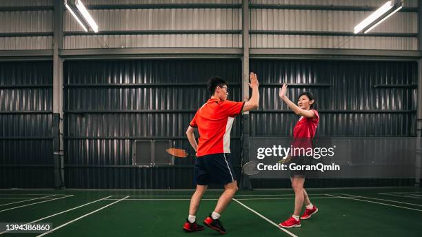 《badminton spirit》high five - badminton smash stock pictures, royalty-free photos & images