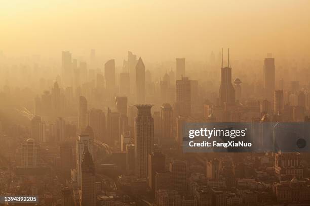 air pollution seen over shanghai's puxi district buildings at dusk, china - smog stock pictures, royalty-free photos & images