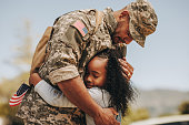 Emotional soldier saying farewell to his daughter