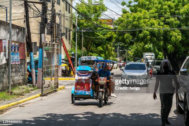 makati metro manila street scene with tricycle - philippines tricycle stock pictures, royalty-free photos & images