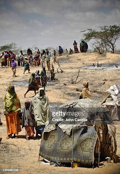 Somalian refugees from the al Shabaab-controlled town of Afgooye make camp on the side of the road on February 20, 2012 in Mogadishu, Somalia. As...