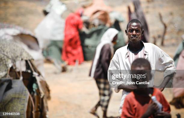 Somalian refugees from the al Shabaab-controlled town of Afgooye make camp on the side of the road on February 20, 2012 in Mogadishu, Somalia. As...