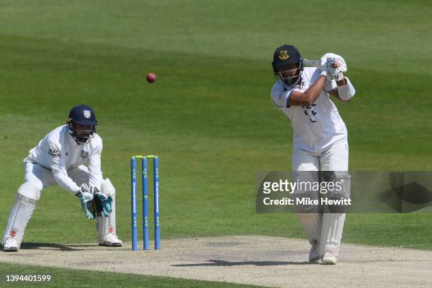 Cheteshwar Pujara of Sussex hits out as wicketkeeper Ned Eckersley of Durham looks on during the LV= Insurance County Championship match between...