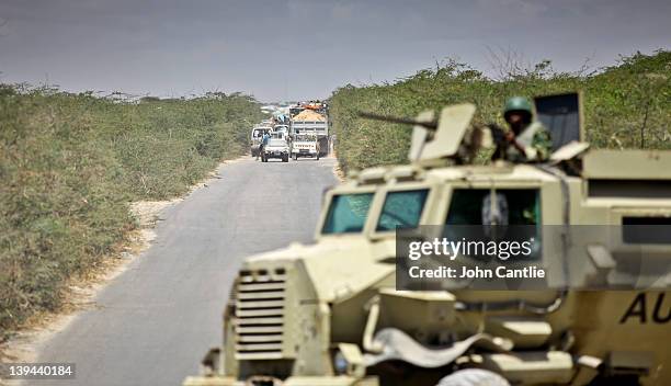 An AMISOM armoured vehicle patrols the main road to Afgooye, from where a steady stream of refugees are escaping anticipated conflict on February 20,...