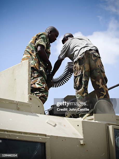 Soldiers reload their weapons on an armoured vehicle before a patrol on February 20, 2012 in Mogadishu, Somalia. As operations against Al Shabaab...