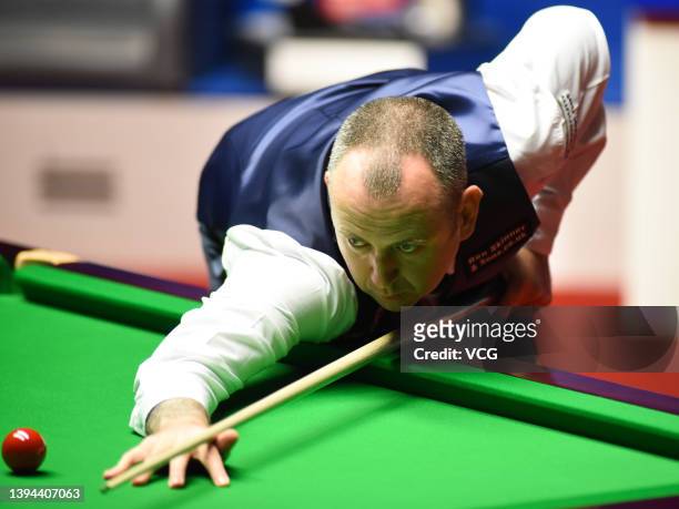 Mark Williams of Wales plays a shot during the semi-final match against Judd Trump of England on day 14 of the Betfred World Snooker Championships...