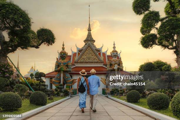 couple love romantic travel at wat arun bangkok or arun temple which famous travel destination in thailand in travel trip during vacation for relaxation. lifestyle couple travel destination concept. - thailand tourism stock pictures, royalty-free photos & images