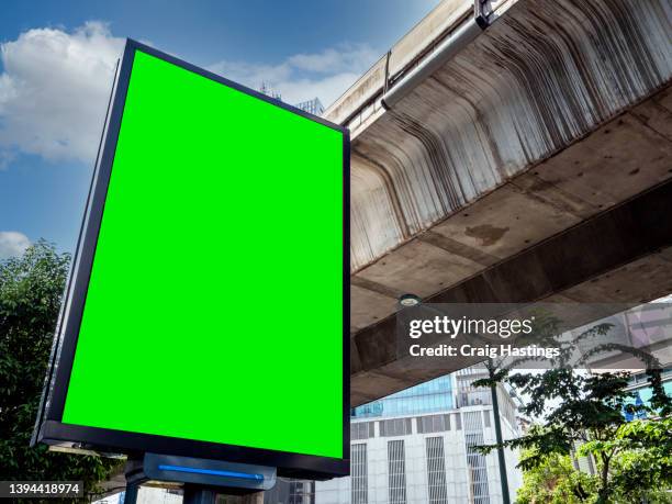 large to medium size green screen chroma key marketing advertisement billboard in city centre urban road freeway highway environment targeting adverts at consumers, retail shoppers, commuters and tourists as they drive past in their cars. - electronic billboard stock pictures, royalty-free photos & images