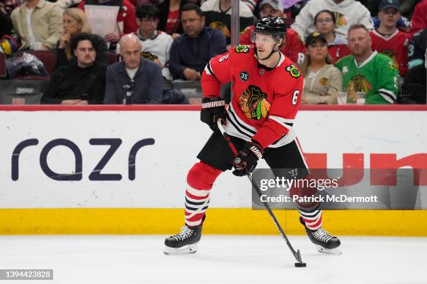 Jake McCabe of the Chicago Blackhawks skates with the puck against the Seattle Kraken in the first period at United Center on April 07, 2022 in...