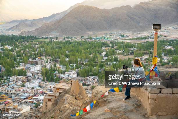 the streets of leh old city are explored by a female tourist - ラホール ストックフォトと画像