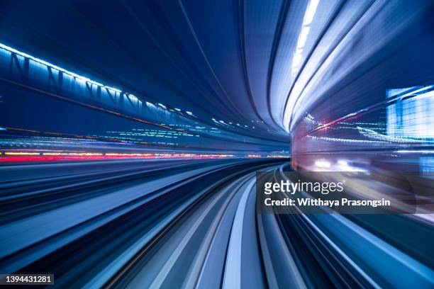 futuristic high speed light tail with night city background - railing stock pictures, royalty-free photos & images