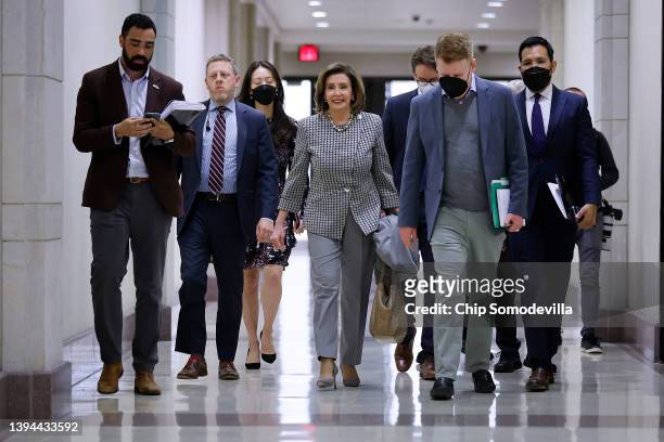 Accompanied by staff and security, Speaker of the House Nancy Pelosi leaves her weekly news conference in the U.S. Capitol Visitors Center on April...