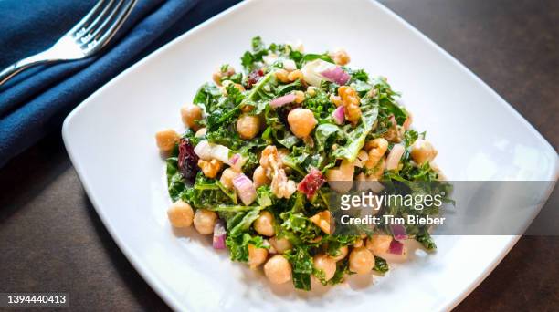 fresh leafy salad with garbanzo chickpeas on white plate from above - walnut farm stock pictures, royalty-free photos & images