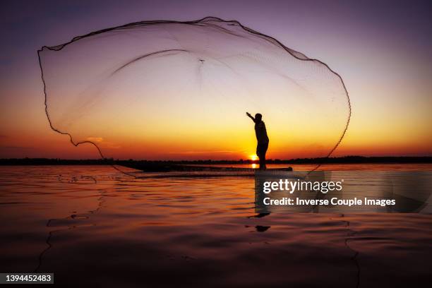 throwing fishing net - sustainable fishing stock pictures, royalty-free photos & images