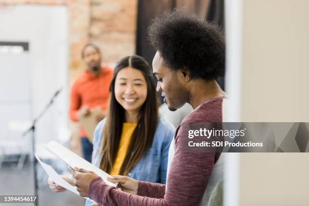 diverse friends read script together before audition - scenario stockfoto's en -beelden