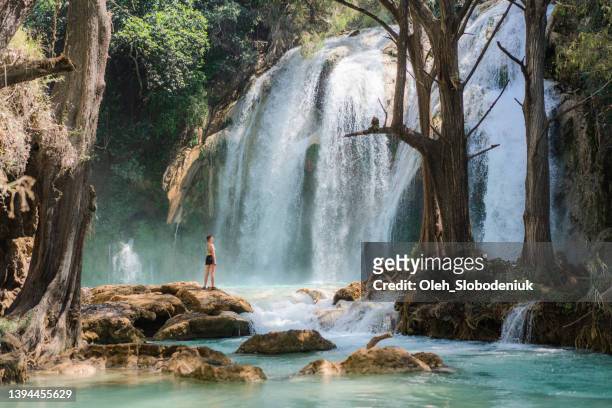woman near el chiflon waterfall in chiapas, mexico - chiapas stock pictures, royalty-free photos & images