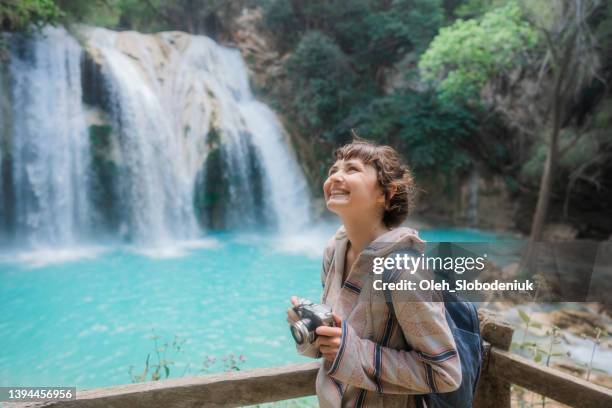 woman photographing near el chiflon waterfall in chiapas, mexico - chiapas stock pictures, royalty-free photos & images