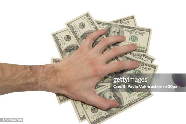 dollar money concept,cropped hand of man holding paper currency against white background - coin in palm of hand stock pictures, royalty-free photos & images