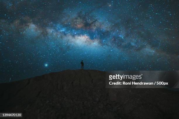 low angle view of silhouette of mountain against star field at night - hendrawan stock pictures, royalty-free photos & images