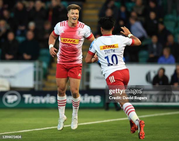 Huw Jones of Harlequins celebrates with teammate Marcus Smith after scoring their team's second try during the Gallagher Premiership Rugby match...