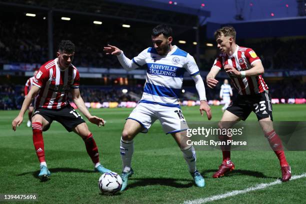 Ilias Chair of Queens Park Rangers battles for possession with John Egan and Ben Osborn of Sheffield United during the Sky Bet Championship match...