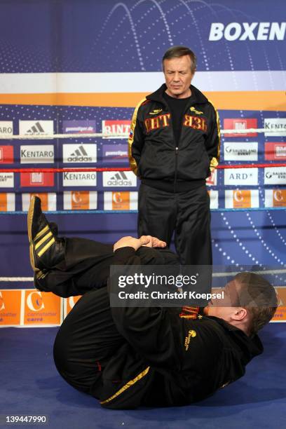 Coach Alexander Zimin watches Alexander Povetkin of Russia boxes during the public training at Canstatter Carre on February 21, 2012 in Stuttgart,...