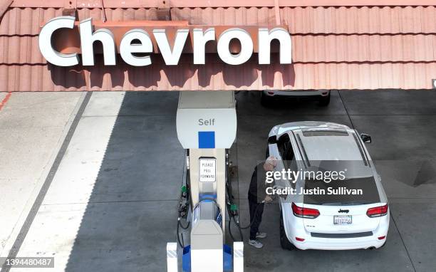 In an aerial view, a customer pumps gas into his vehicle at a Chevron gas station on April 29, 2022 in Mill Valley, California. Chevron reported...