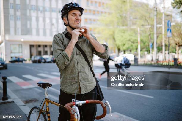 mid aged man getting ready for commuting - bike riding stock pictures, royalty-free photos & images